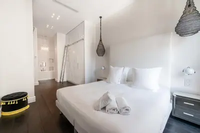 a bedroom with a white bed with towels on it at Prestige & Comfort Facing the Palais des Festivals in Cannes