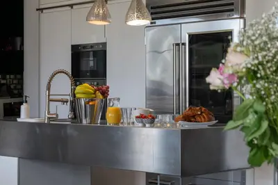 a kitchen with a counter with food on it at Prestige & Comfort Facing the Palais des Festivals in Cannes