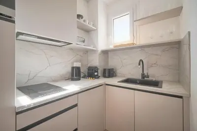 a kitchen with white cabinets and a sink at Elégant studio TERRASSE- proche PLAGES et CROISETTE A0B206 in Cannes