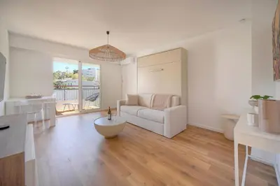a white living room with a couch and a table at Elégant studio TERRASSE- proche PLAGES et CROISETTE A0B206 in Cannes