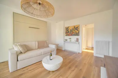 a living room with a couch and a table at Elégant studio TERRASSE- proche PLAGES et CROISETTE A0B206 in Cannes