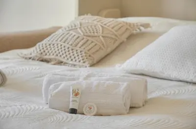 a pile of towels sitting on a bed at Elégant studio TERRASSE- proche PLAGES et CROISETTE A0B206 in Cannes