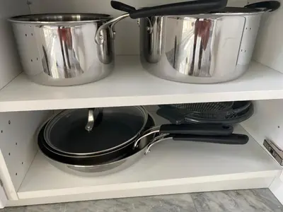 two pots and pans on a shelf in a kitchen at L'Astrolabe - Studio - refurbished - seaside in Cannes