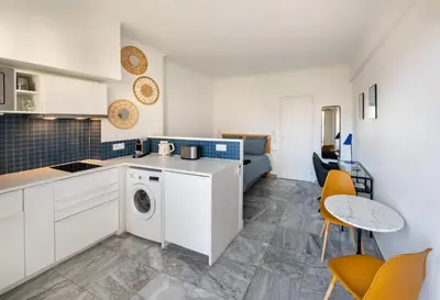 a glass desk with a chair and a mirror at L'Astrolabe - Studio - refurbished - seaside in Cannes