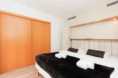 a bedroom with two beds with towels on them at Pavillon Riviera YourHostHelper in Cannes