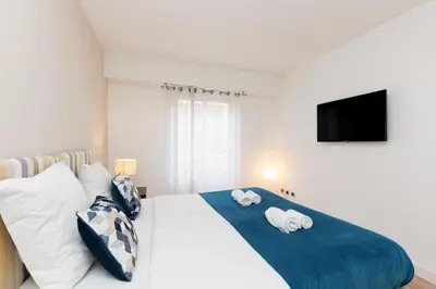 a bedroom with a bed with two towels on it at Pavillon Riviera YourHostHelper in Cannes