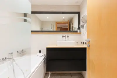 a bathroom with a sink and a bath tub at Pavillon Riviera YourHostHelper in Cannes