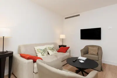 a living room with a couch and a table at Pavillon Riviera YourHostHelper in Cannes