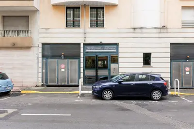 a blue car parked in front of a building at Pavillon Riviera YourHostHelper in Cannes