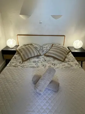 a bed with two pillows and two towels on it at BY NEPTUNE - La Palme Azur Beach view in Cannes