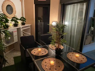 a living room with two tables with candles on them at BY NEPTUNE - La Palme Azur Beach view in Cannes