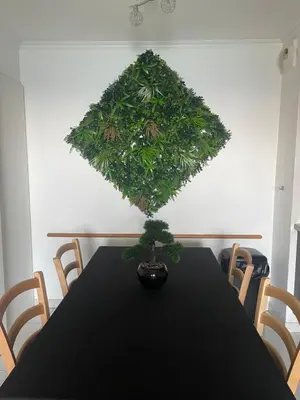a black table with a plant on the wall at BY NEPTUNE - La Palme Azur Beach view in Cannes