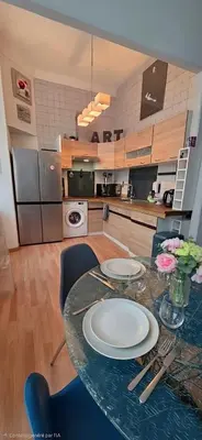 a living room with a glass table and black chairs at Centre Carré d'or 3 chambres in Cannes