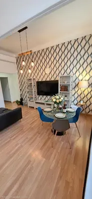 a living room with a couch and a tv at Centre Carré d'or 3 chambres in Cannes