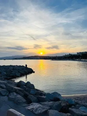 a person standing on the rocks near a body of water at Charmant Studio - Centre Cannes in Cannes