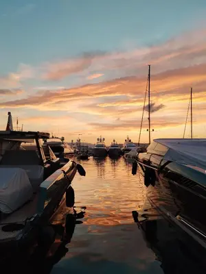 a group of boats docked in the water at sunset at La Californie Views II in Cannes
