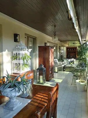 a living room with a wooden bench and a bird cage at La Californie Views II in Cannes