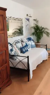 a bedroom with a bed with blue and white pillows at La Californie Views II in Cannes