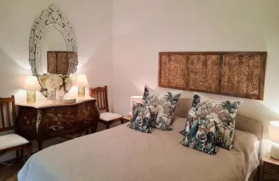 a bedroom with a bed with pillows and a mirror at La Californie Views II in Cannes