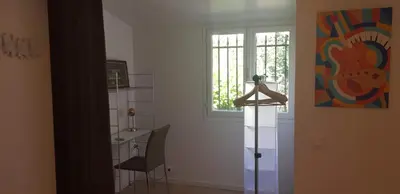 a room with a table and a chair and a window at Appartement 2 pièces cannes in Cannes