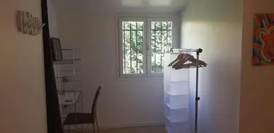 a room with a window and a table and a chair at Appartement 2 pièces cannes in Cannes