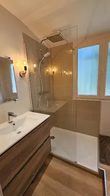 a bathroom with a shower and a sink and a glass shower stall at Appartement 2 pièces cannes in Cannes