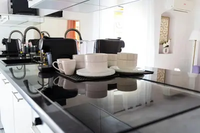 a kitchen counter with cups and plates on it at Apartment in Cannes in Cannes