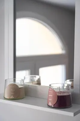 two candles sitting on a shelf in front of a mirror at Apartment in Cannes in Cannes