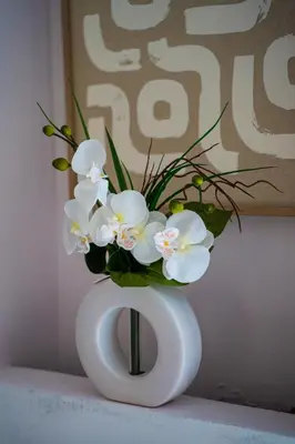 a white vase with white flowers in it at Apartment in Cannes in Cannes