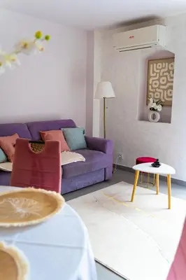 a living room with a purple couch and a table at Apartment in Cannes in Cannes