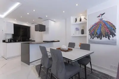 a kitchen and dining room with a table and chairs at Croisette Star - Bd Croisette in Cannes