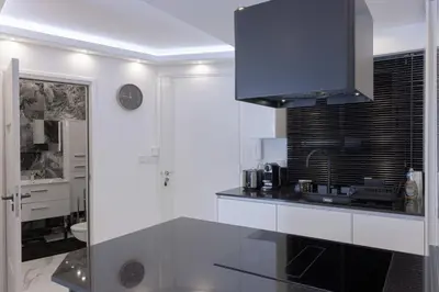 a white kitchen with a sink and a microwave at Croisette Star - Bd Croisette in Cannes