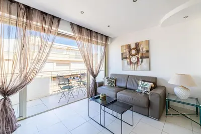 a living room with a couch and a table at Latour Maubourg 20 by Halldis in Cannes