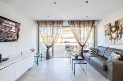 a living room with a couch and a table at Latour Maubourg 20 by Halldis in Cannes