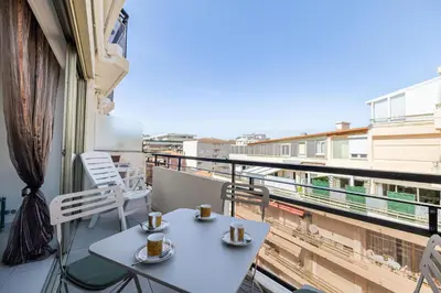 a balcony with a table and two cups of coffee at Latour Maubourg 20 by Halldis in Cannes
