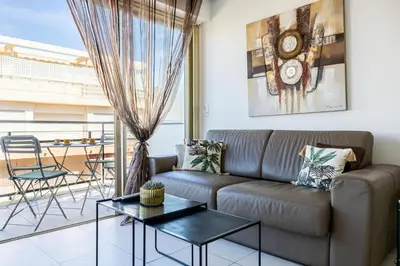 a living room with a couch and a table at Latour Maubourg 20 by Halldis in Cannes