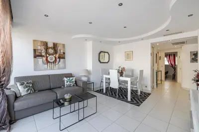 a living room with a couch and a table at Latour Maubourg 20 by Halldis in Cannes