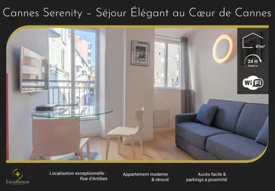 a living room with a blue couch and a glass table at Cannes Serenity – Elegant Stay in Central Cannes in Cannes