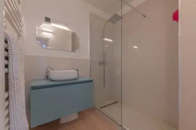 a bathroom with a glass shower with a toilet at Cannes Serenity – Elegant Stay in Central Cannes in Cannes