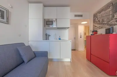 a living room with a couch and a red refrigerator at Cannes Serenity – Elegant Stay in Central Cannes in Cannes