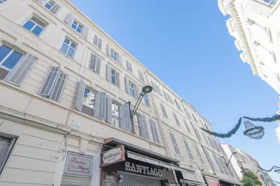 a large building with shops in front of it at Cannes Serenity – Elegant Stay in Central Cannes in Cannes