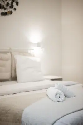 a white towel laying on a bed in a room at Elegant 2P Rue Meynadier 350 m Palais & beaches in Cannes