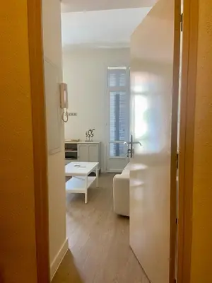 a white living room with a couch and a table at Elegant 2P Rue Meynadier 350 m Palais & beaches in Cannes