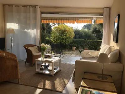 a living room with a couch and a table at Les Oliviers 3, Domaine de Pierre Longue in Cannes