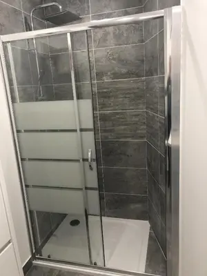 a shower with a glass door in a bathroom at Les Oliviers 3, Domaine de Pierre Longue in Cannes