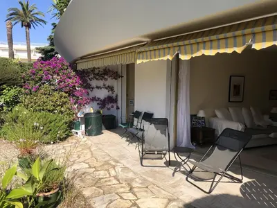 a group of chairs sitting on a patio at Les Oliviers 3, Domaine de Pierre Longue in Cannes