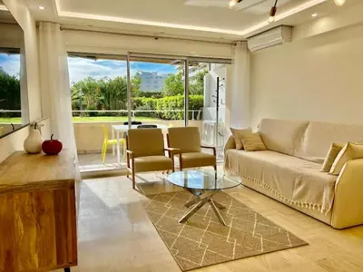 a living room with a couch and a table at 90 m2, 5 min walk to Croisette, Basse Californie in Cannes