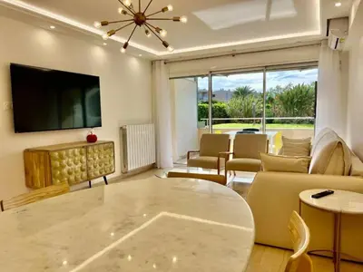 a living room with a couch and a table at 90 m2, 5 min walk to Croisette, Basse Californie in Cannes