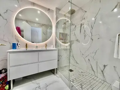 a white bathroom with a sink and a mirror at 90 m2, 5 min walk to Croisette, Basse Californie in Cannes