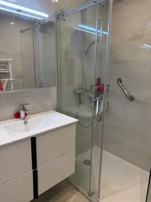 a bathroom with a glass shower and a sink at Central location, terrace, 2 bedrooms in Cannes